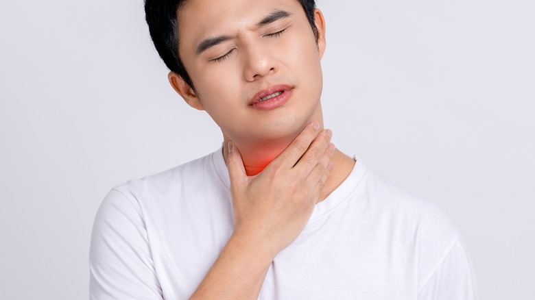 Asian man with sore throat