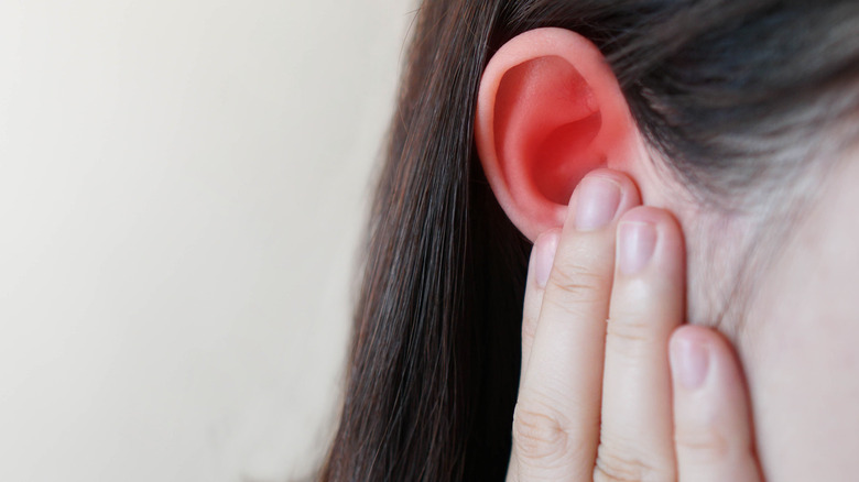 woman suffering from ear pain