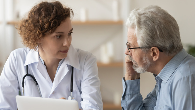 doctor talking to older male patient