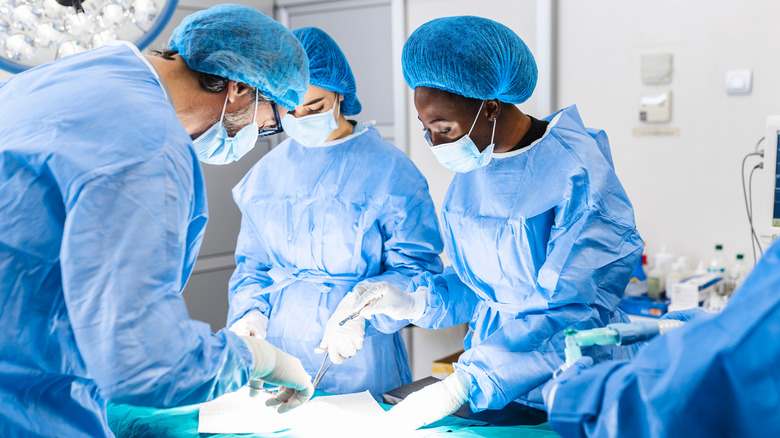 Surgical team operating on patient