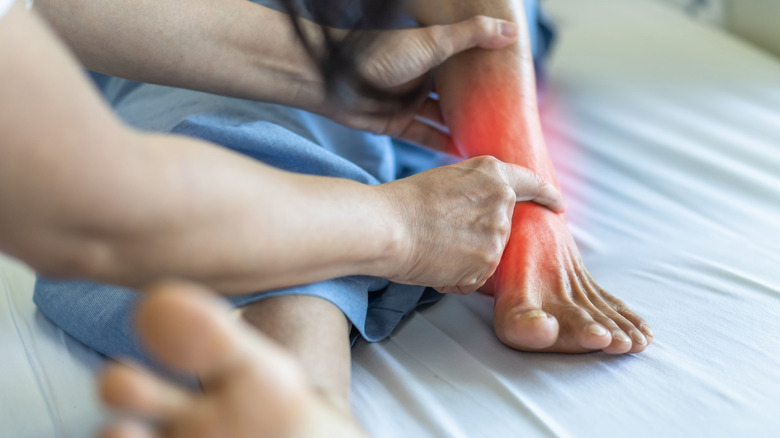 doctor touching patient's painful foot