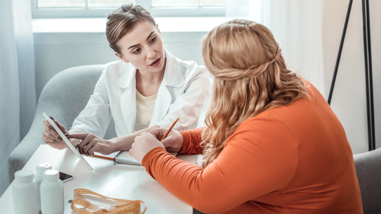 overweight woman with doctor