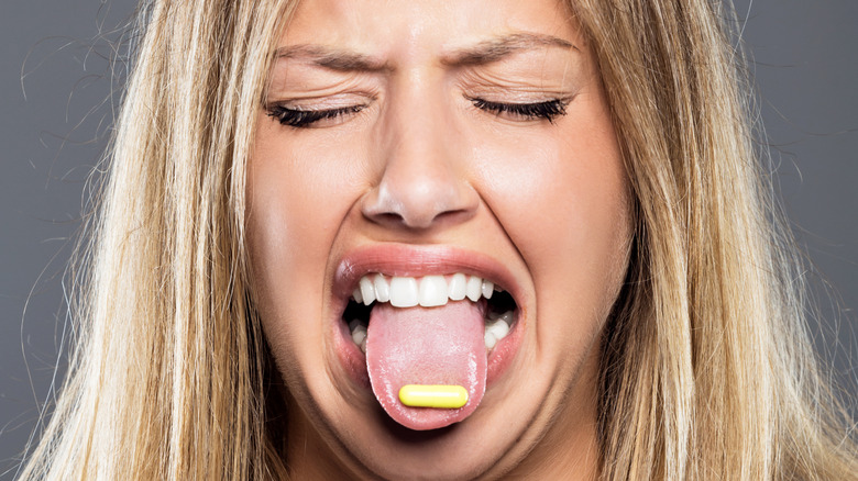 woman with bad tasting pill