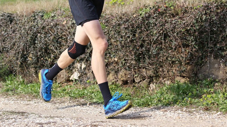 Man running with a knee brace