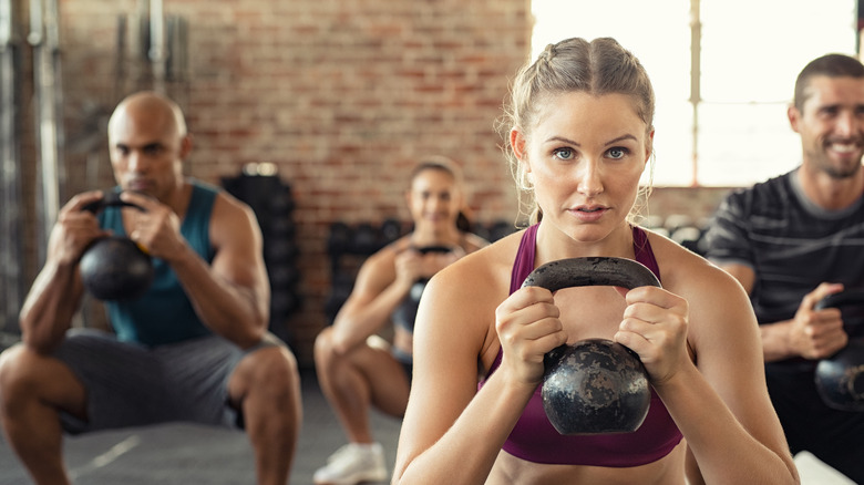 People lifting kettleballs