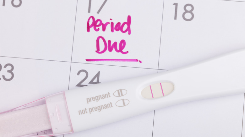 Positive pregnancy test over calendar