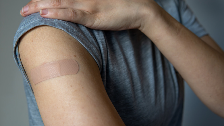 Close up of woman's arm with bandaid