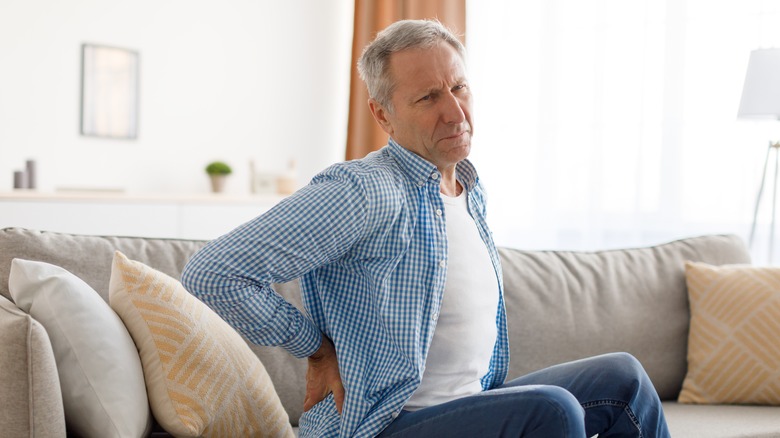 man holding his hip