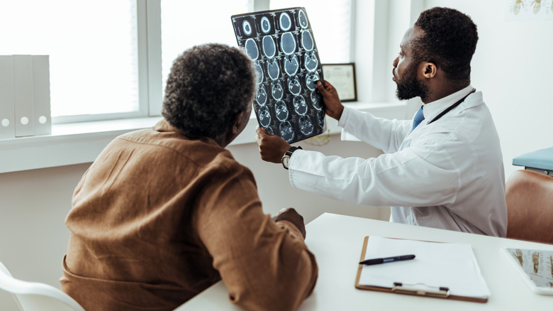 Doctor and patient examining brain scan