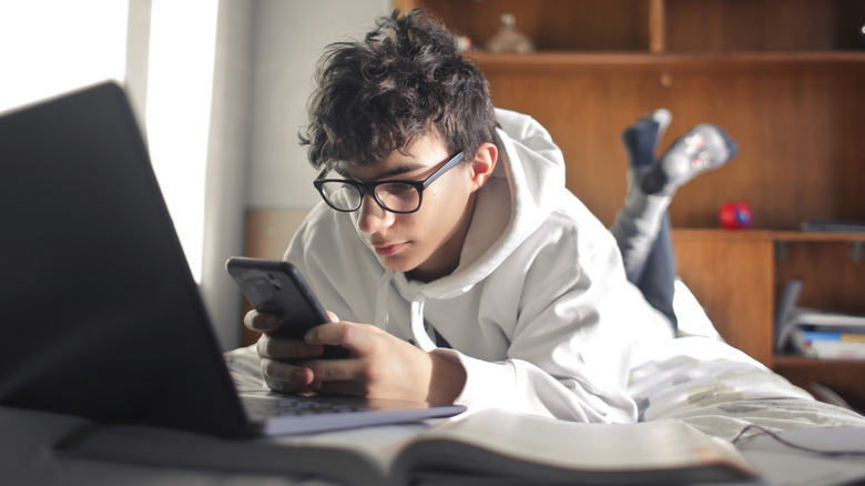 teenager on phone and computer