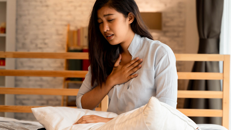 woman experiencing shortness of breath in bed