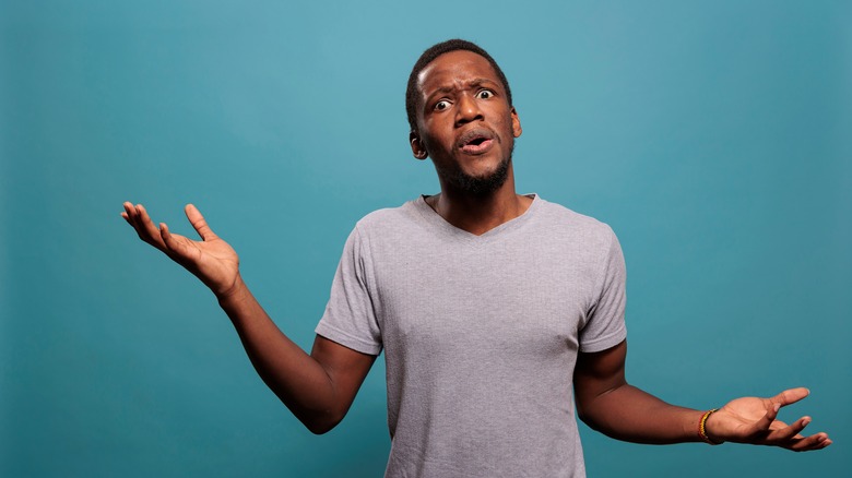 confused man against blue background