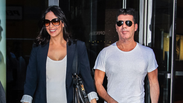 Simon Cowell walks with his girlfriend, Lauren