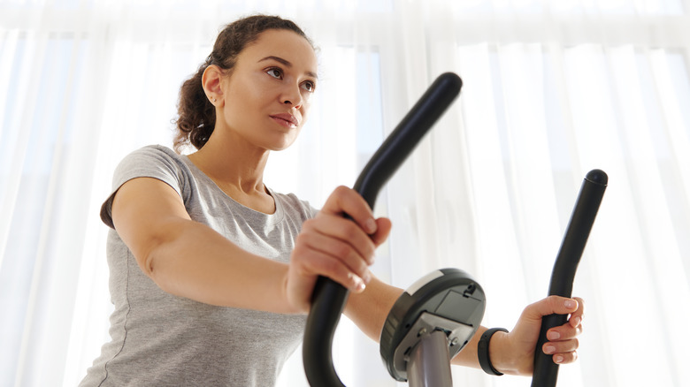 woman exercising on a stationary bike