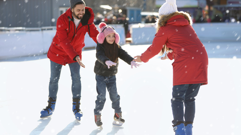 Family skating during winter holiday