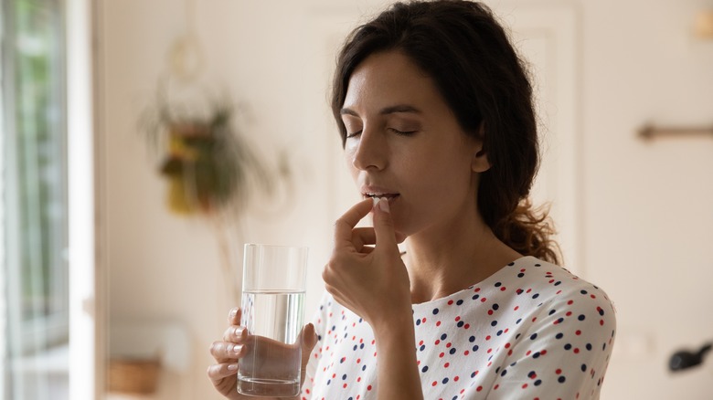 woman taking pain medications