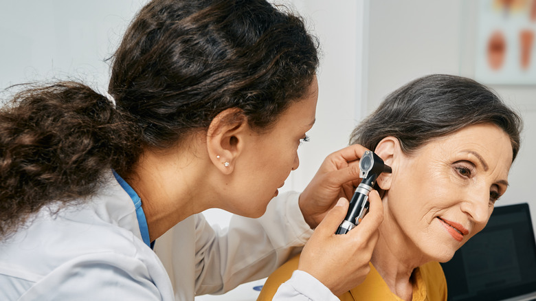 doctor checking patient's ear