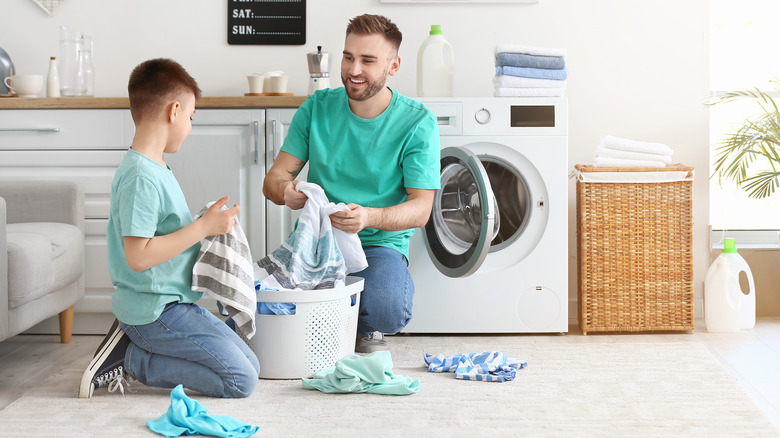 Father and son washing laundry