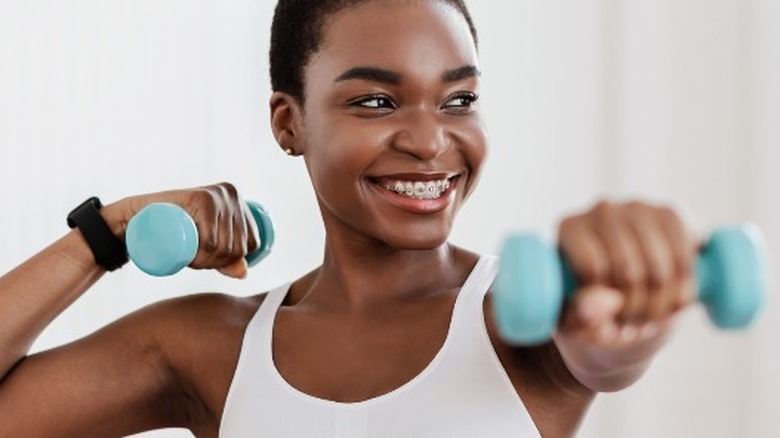 Young woman lifting weights