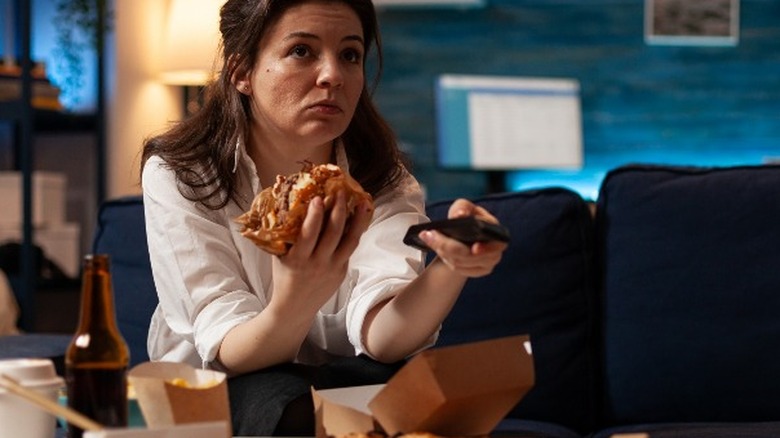 Woman eating and watching TV