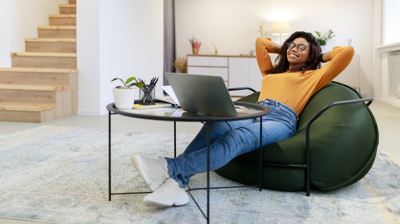 woman leaning back from her computer