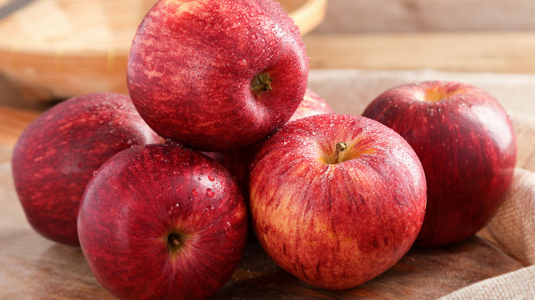 apples on wood cutting board