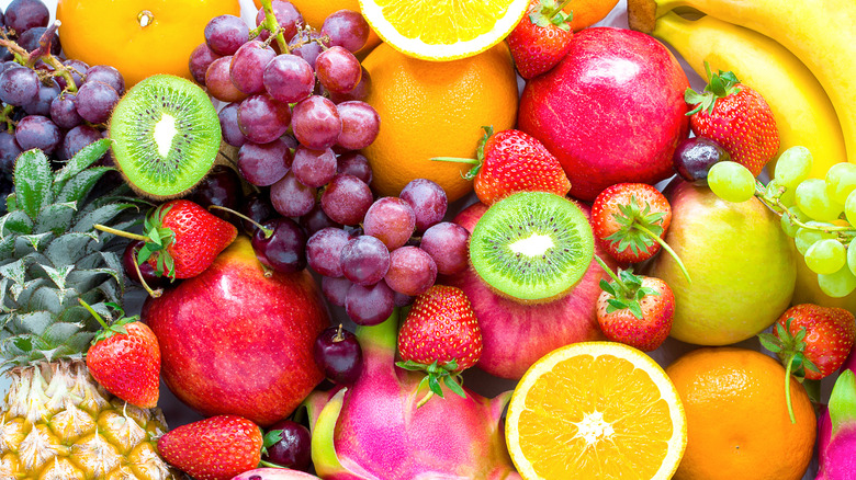 variety of fruits like grapes, oranges, bananas, kiwis