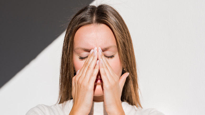 Woman rubbing her sinuses