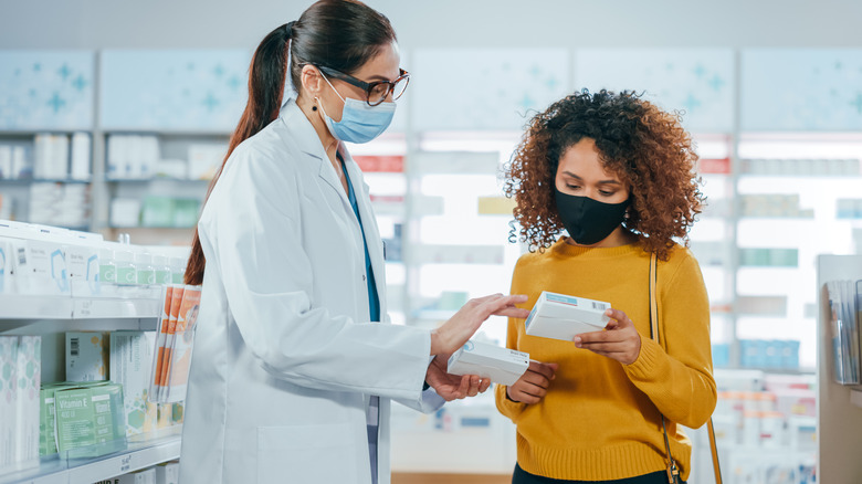 Pharmacist helping patient with medication