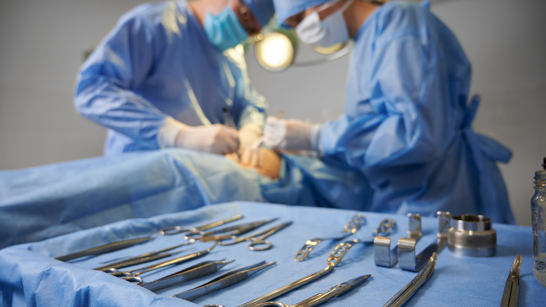 Surgeons in an operating room with tools