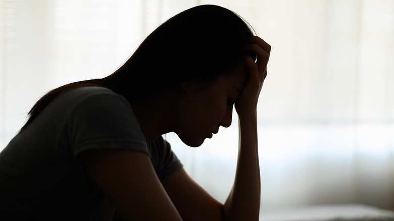 Woman iin profile with a migraine