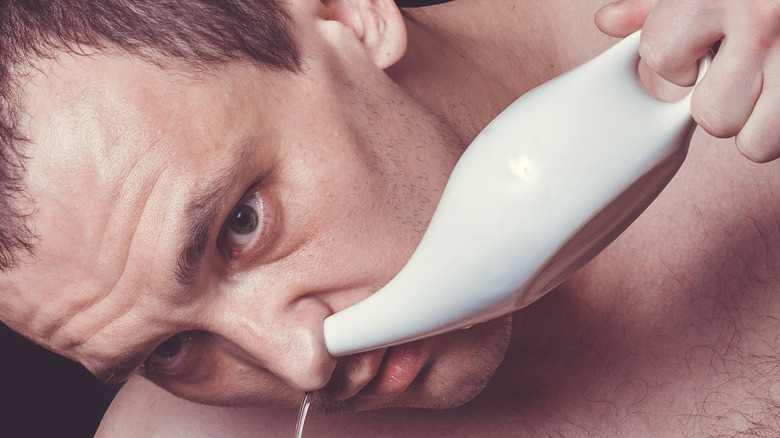 man using neti pot