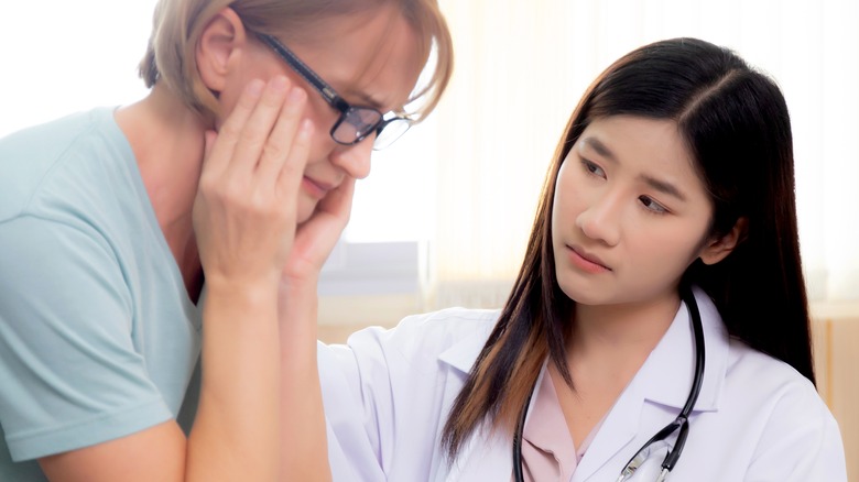 worried woman speaking with doctor