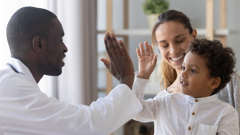 doctor giving high five to patient