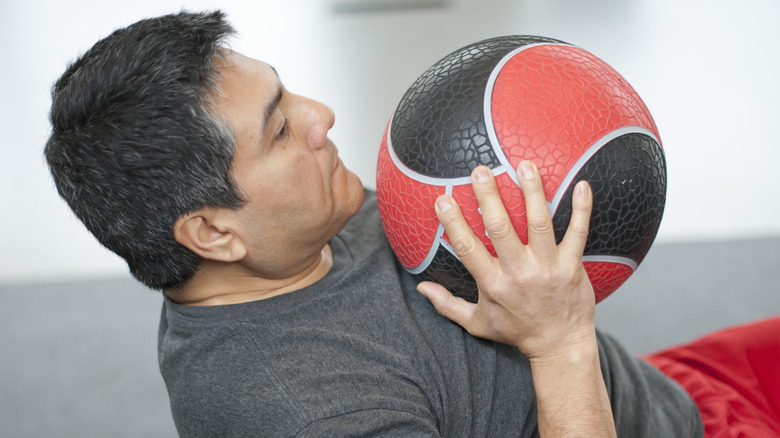 man working out with medicine ball