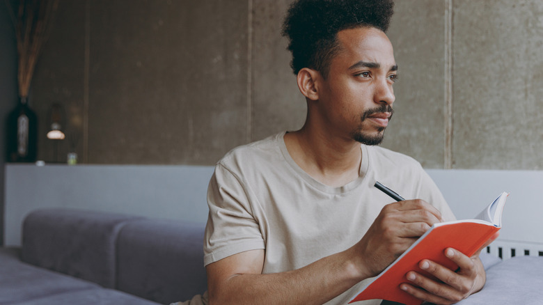 Man writing in journal