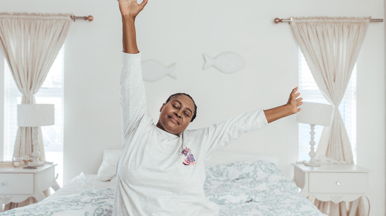 Woman stretching in bed