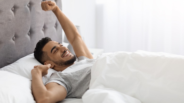 man waking up refreshed