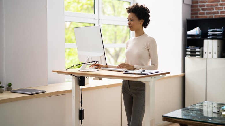 woman with good posture working at a standing desk