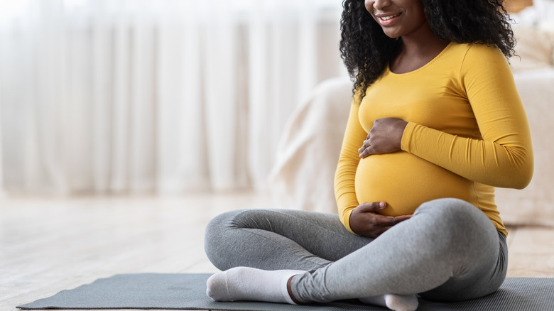 pregnant woman holding belly