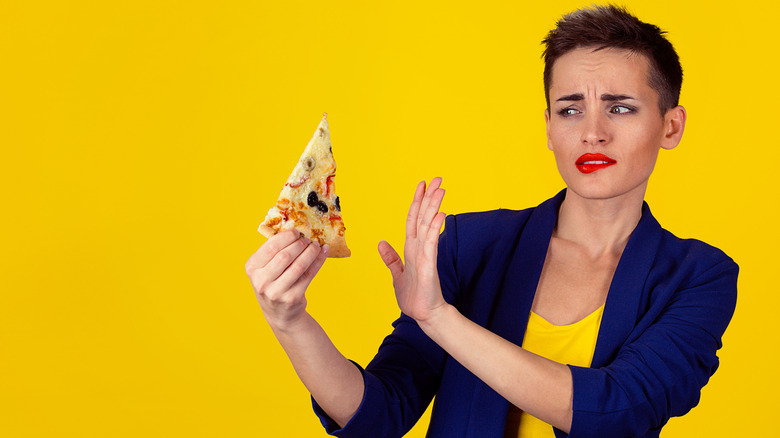 woman refusing pizza