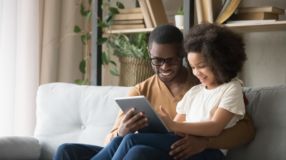 Father and daughter on tablet