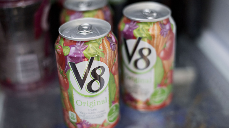 cans of V8 on refrigerator shelf