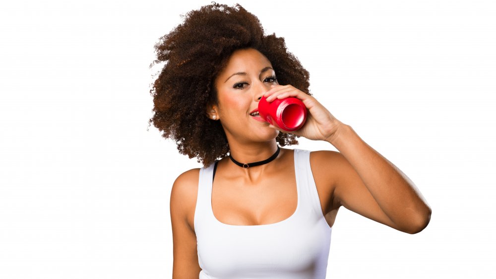 A woman drinking soda