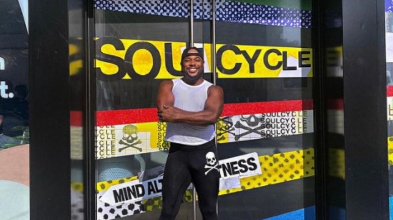 Kamelle Mills standing outside in front of a SoulCycle sign