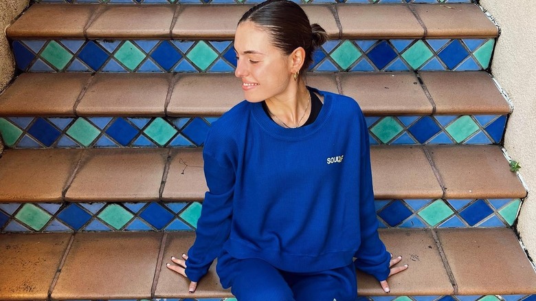 Kitty Terzo in sweats sitting on step