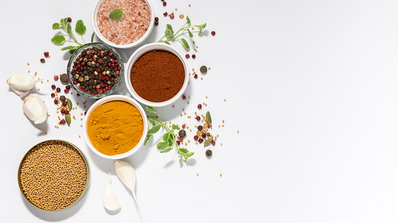Spices in bowls on a white background