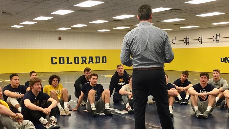 Dr. Jarrod Spencer speaking to a group of young wrestlers