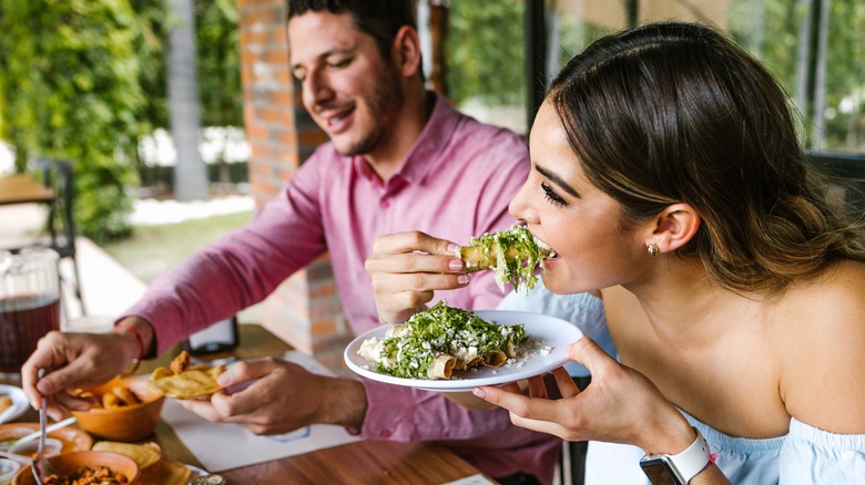 man and woman enjoying a meal