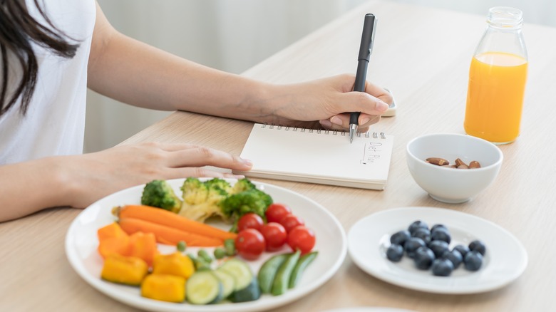 A woman writes in a food diary